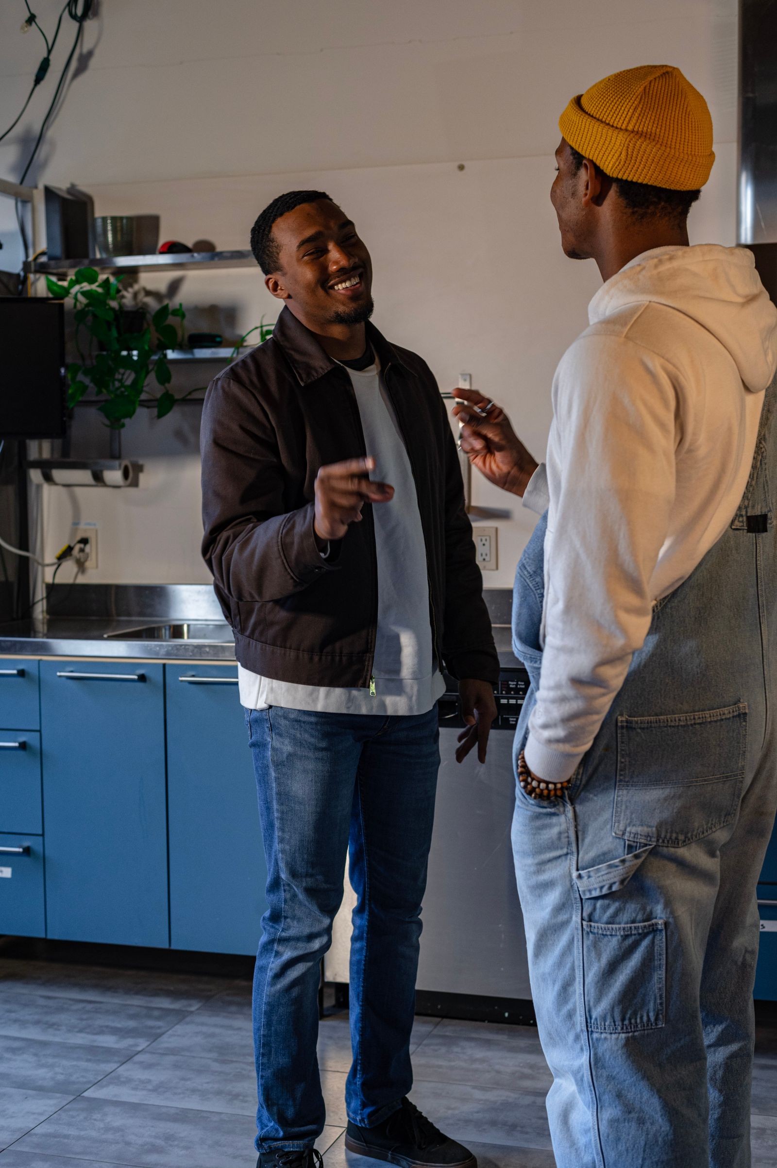 Two people talking and smiling in a kitchen