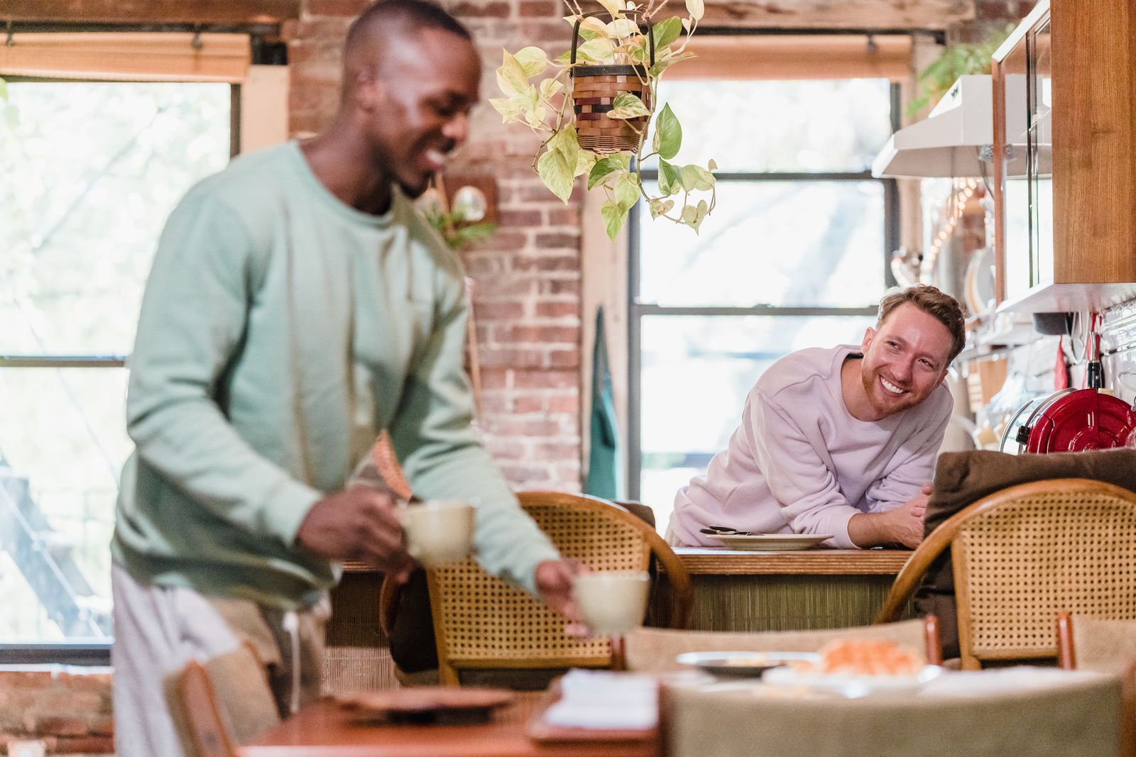 Two people sharing a meal and coffee in a bright kitchen