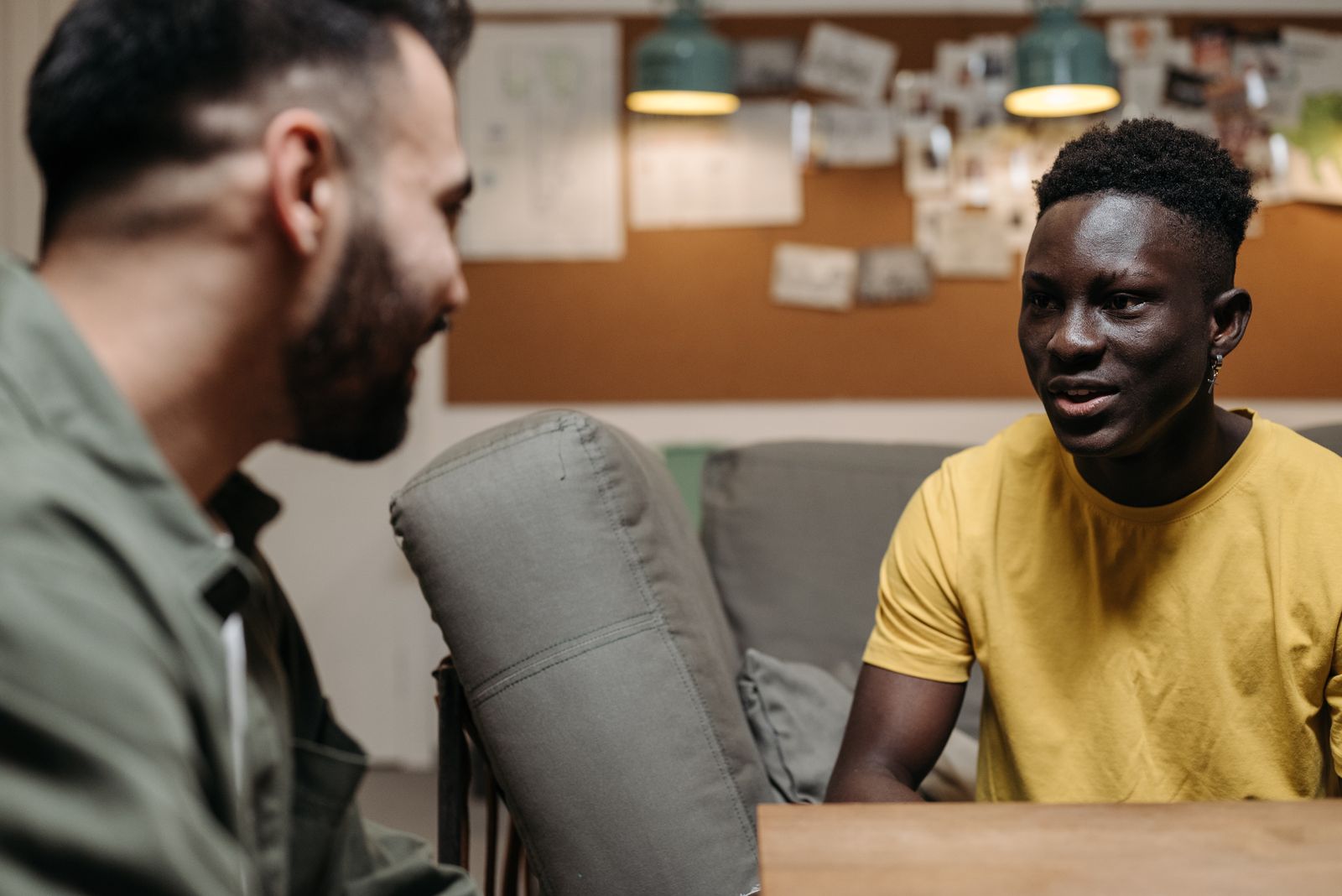 Two people talking together in a living room